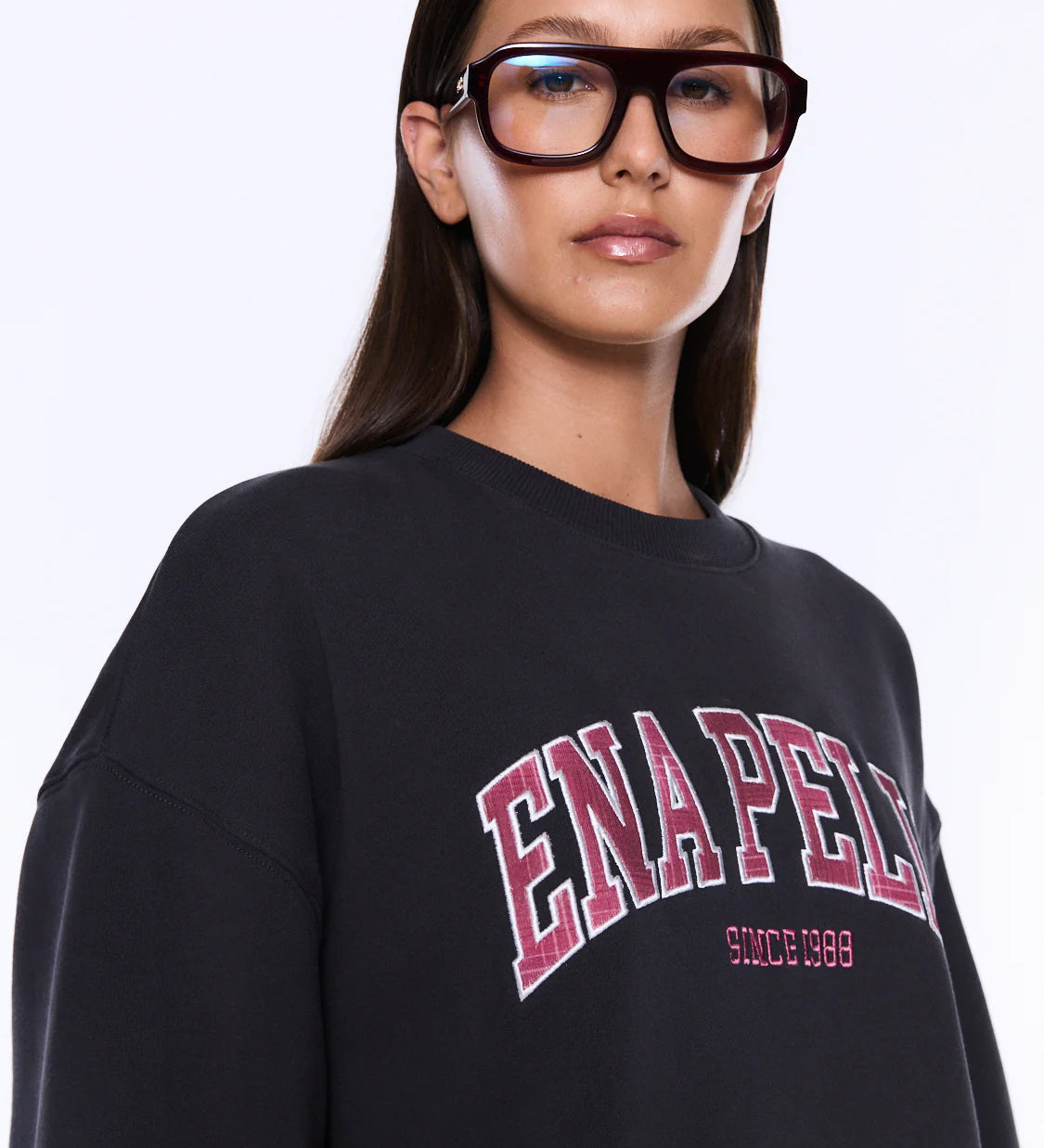 Person wearing a black sweatshirt with 'ENAPED' text on a white background