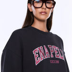 Person wearing a black sweatshirt with 'ENAPED' text on a white background