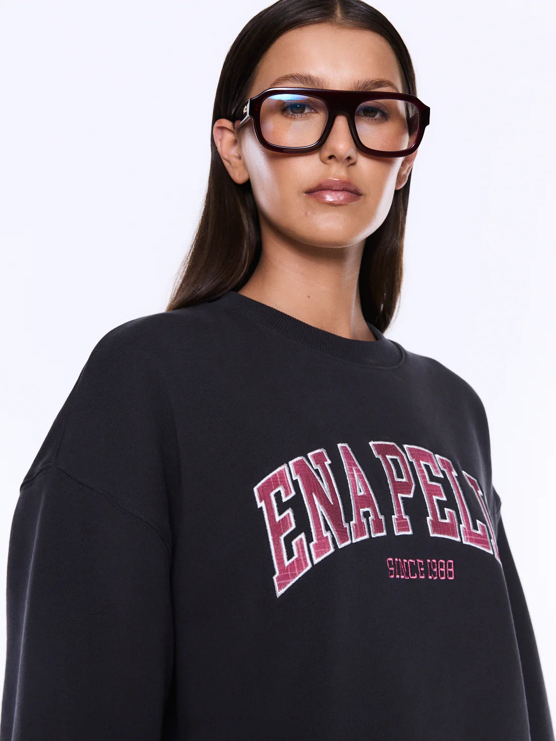 Person wearing a black sweatshirt with 'ENAPED' text on a white background