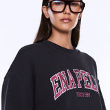 Person wearing a black sweatshirt with 'ENAPED' text on a white background