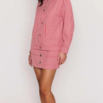 Woman wearing a red and white striped outfit on a white background