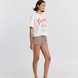 Woman wearing a graphic t-shirt and striped shorts on a white background