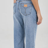Light blue jeans worn by a person on a white background