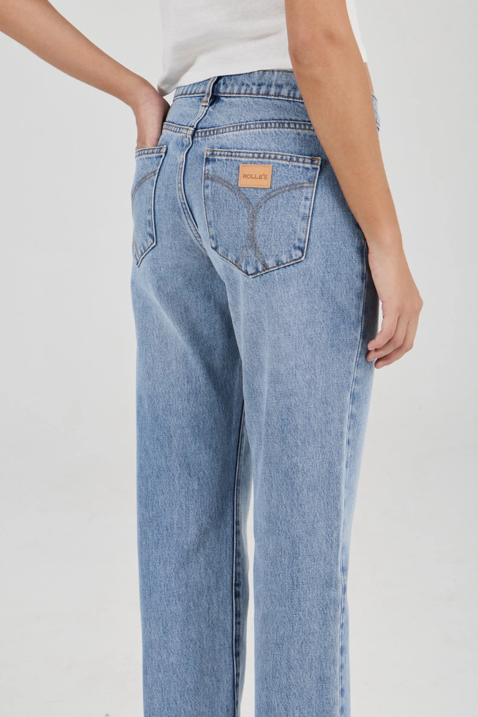 Light blue jeans worn by a person on a white background