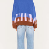 Person wearing a colorful sweater with a white background
