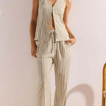 Woman wearing a striped outfit with a white background