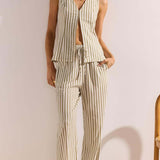 Woman wearing a striped outfit with a white background