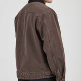 Man wearing a brown jacket on a plain background