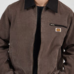 Brown jacket with a logo patch on a white background