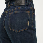 Dark blue jeans with a visible brand label on a white background