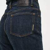 Dark blue jeans with a visible brand label on a white background