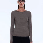 Woman wearing a striped long-sleeve shirt and glasses on a white background