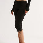 Person wearing black leggings with a white background