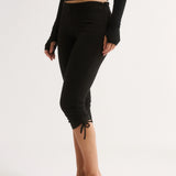 Person wearing black leggings with a white background