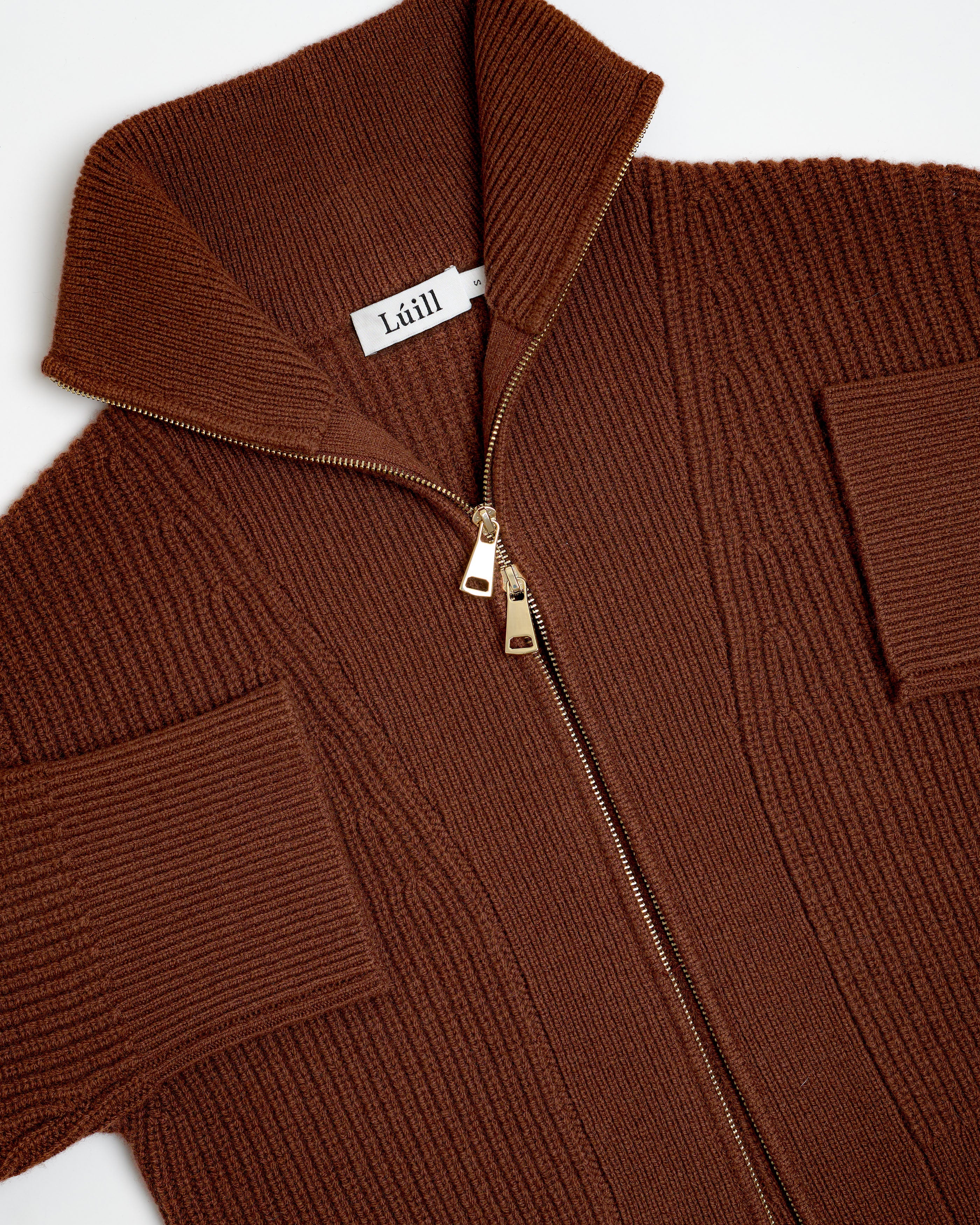 Brown knit jacket with a zipper and 'Léll' brand tag on a white background