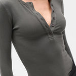 Gray long-sleeve henley shirt worn by a person on a white background