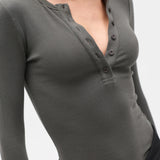 Gray long-sleeve henley shirt worn by a person on a white background