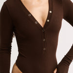 Brown bodysuit with long sleeves on a white background
