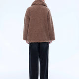 Person wearing a brown fluffy coat on a white background