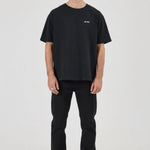 Man wearing a black t-shirt and pants on a white background