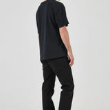 Person wearing a black t-shirt and black pants on a white background