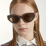 Person wearing dark sunglasses with a neutral background
