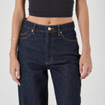 Person wearing dark blue jeans and a black crop top on a white background