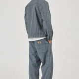 Person wearing a gray checkered jacket and pants on a white background