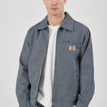 Man wearing a blue striped jacket with a visible brand logo on a white background