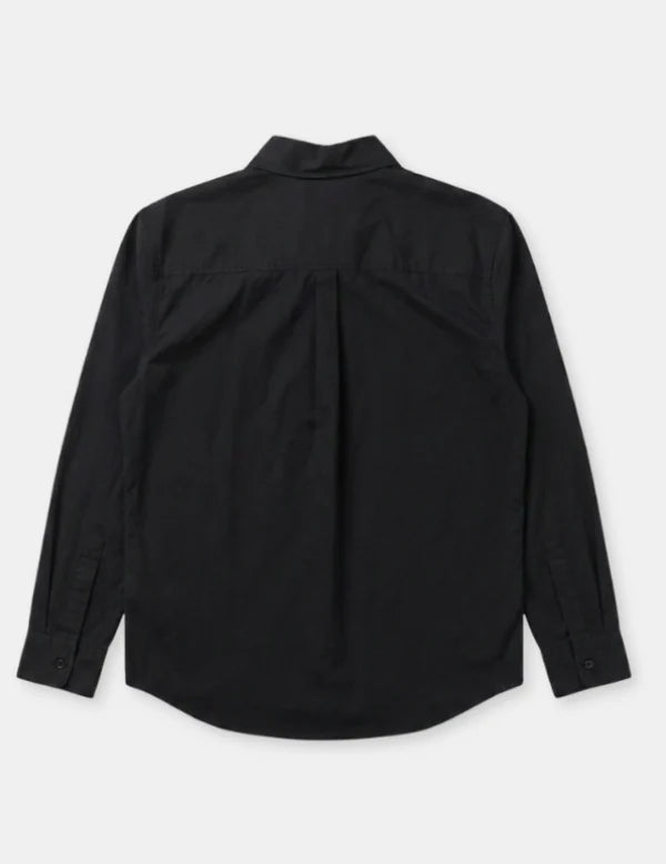 A black long-sleeve button-up shirt shown from the back, featuring a subtle vertical pleat down the center back, laid flat against a light gray background.