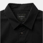 Close-up of a black long-sleeve button-down shirt collar with a visible MR SIMPLE neck label, on a light gray background.