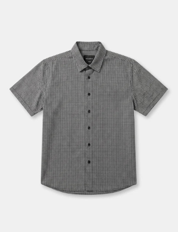 A short-sleeve button-up shirt with a small black and white micro-check pattern, displayed flat against a light gray background.