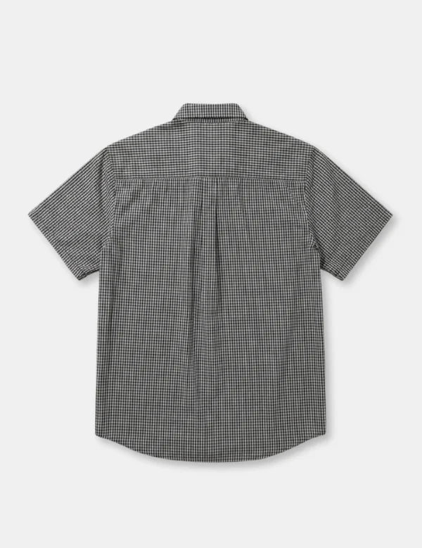 A short-sleeve button-up shirt with a small-scale black and white micro-check pattern, shown from the back on a light gray background.