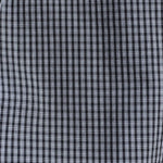 A close-up of a black and white checkered fabric pattern, showing the fine grid texture of the plaid.
