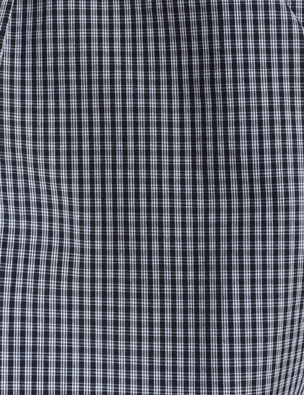 A close-up of a black and white checkered fabric pattern, showing the fine grid texture of the plaid.