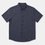 A short-sleeve button-up shirt with a navy blue base and thin white vertical pinstripes, displayed flat against a light gray background.