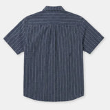 A short-sleeve button-up shirt with vertical white pinstripes on a navy blue base, shown from the back against a light gray background.