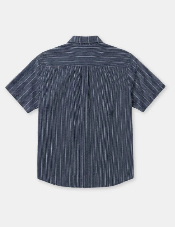 A short-sleeve button-up shirt with vertical white pinstripes on a navy blue base, shown from the back against a light gray background.