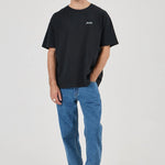 Man wearing a black t-shirt and blue jeans on a white background