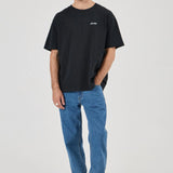 Man wearing a black t-shirt and blue jeans on a white background