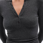 Gray long-sleeve shirt worn by a person on a white background