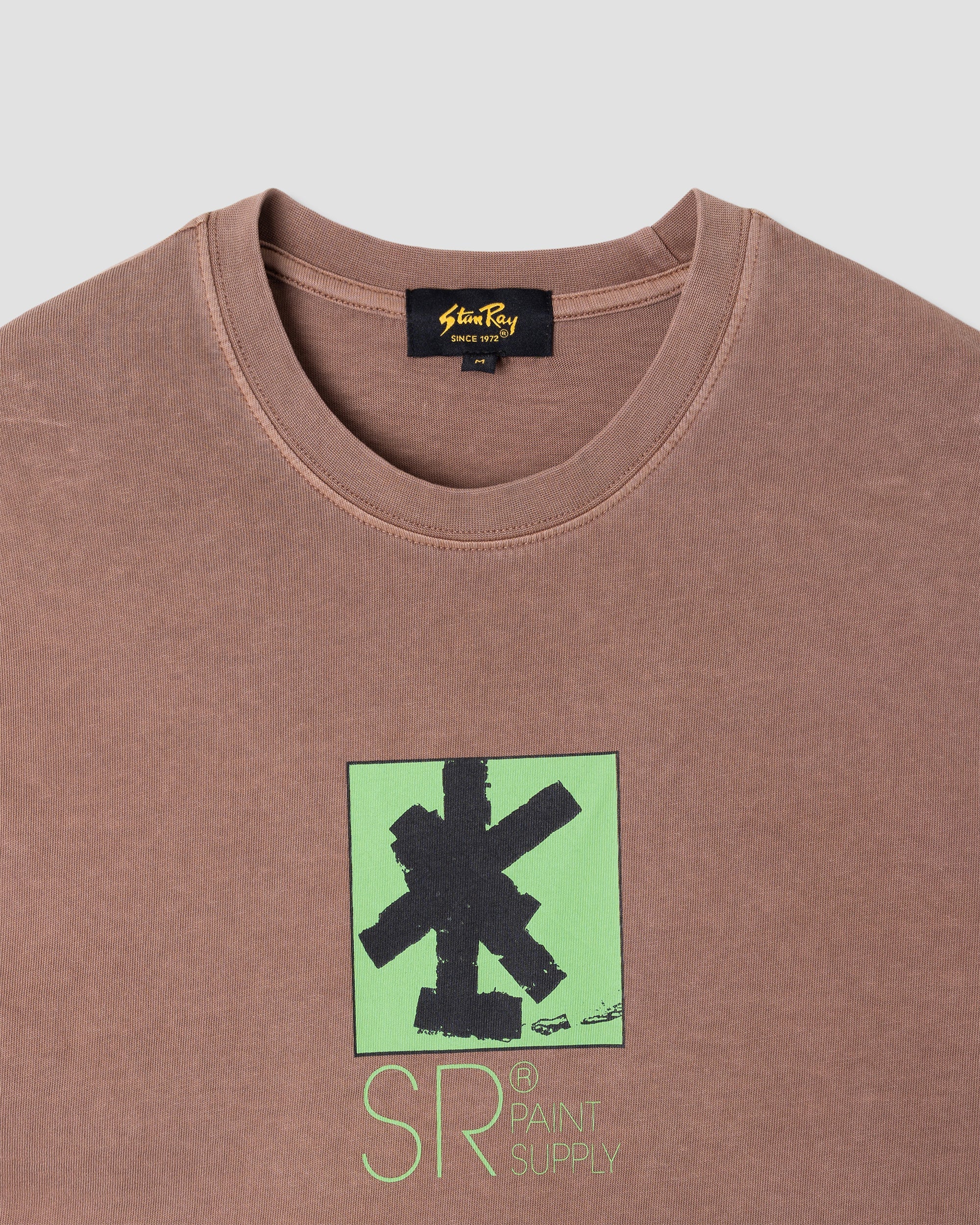 Brown t-shirt with green and black graphic design on a white background