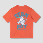 Orange t-shirt with graphic design and text on a gray background
