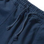 Close-up of blue shorts with drawstring on a white background