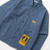Blue shirt with a yellow label on a white background