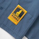 Blue shirt with a 'Service Works' patch on a white background