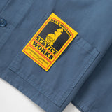 Blue shirt with a 'Service Works' patch on a white background