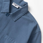 Blue shirt with brand labels on a white background