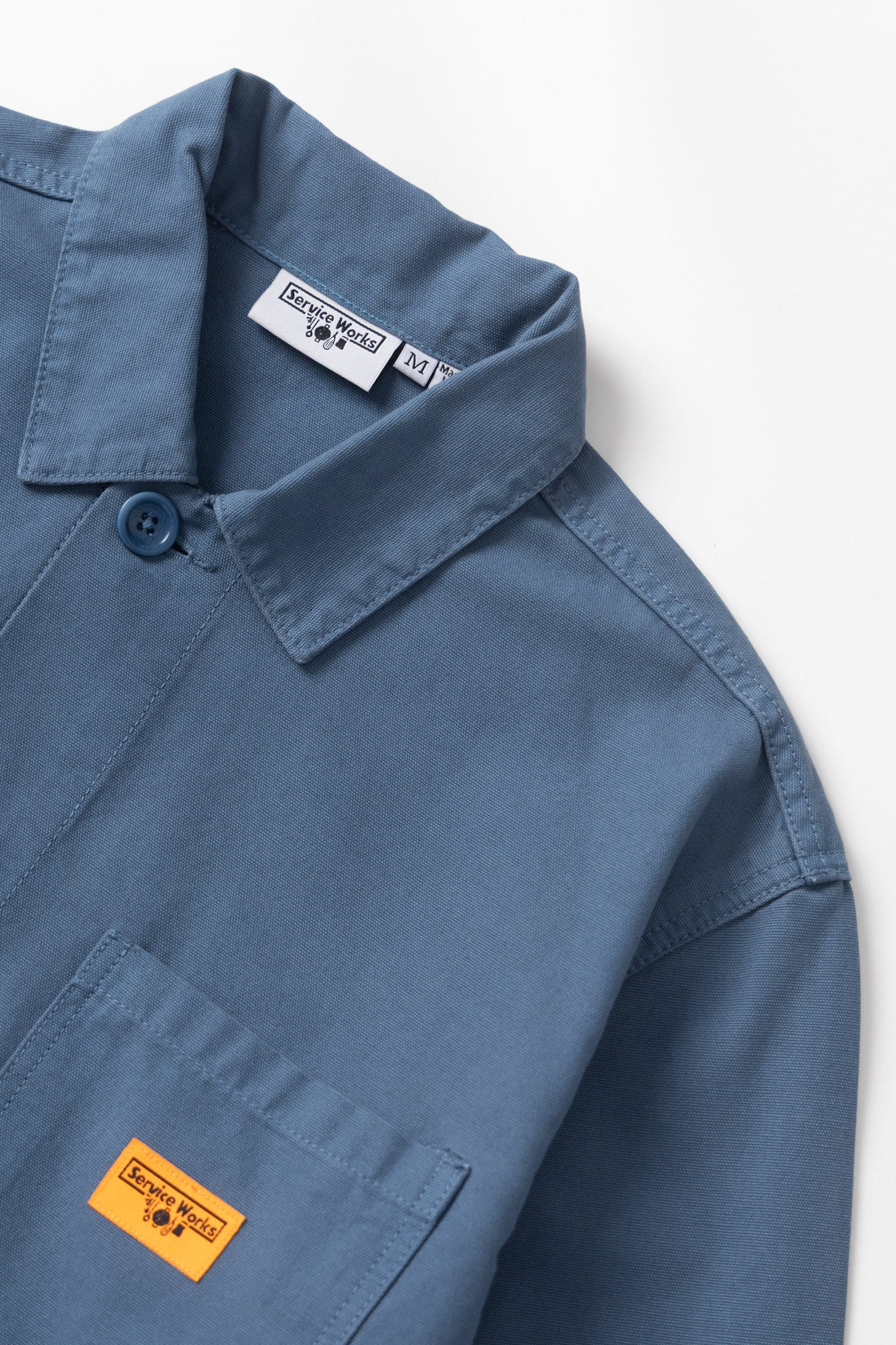 Blue shirt with brand labels on a white background