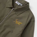 Green jacket with yellow embroidery and a brand label on a white background